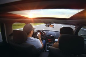 A male driving a vehicle and texting at the same time