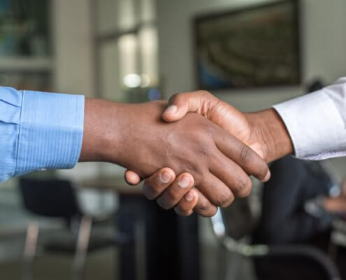 A close up of two people shaking hands