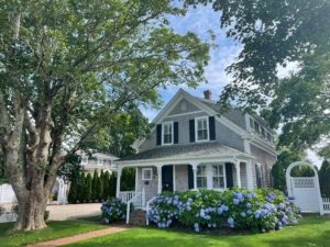 A photo of the front of a home with landscaped yard