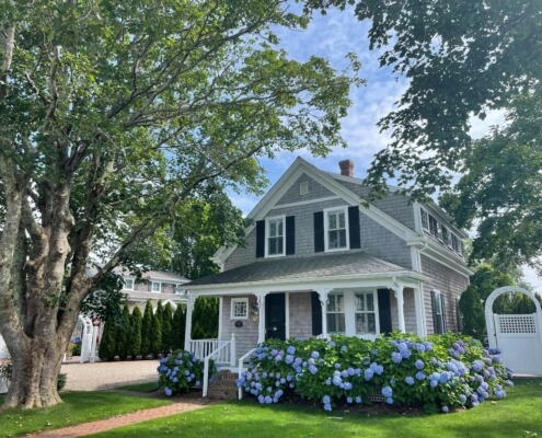 A photo of the front of a home with landscaped yard