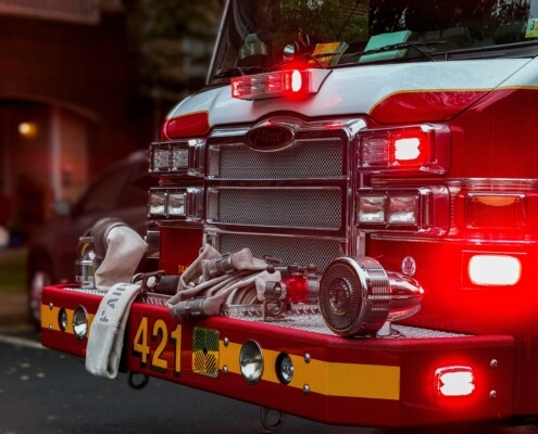 A zoomed photo of the front of a red fire truck