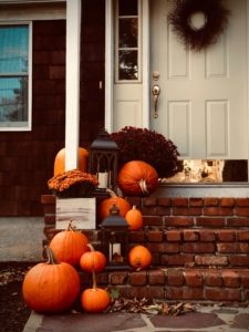 pumpkins line the doorstep of a home