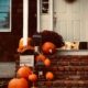 pumpkins line the doorstep of a home